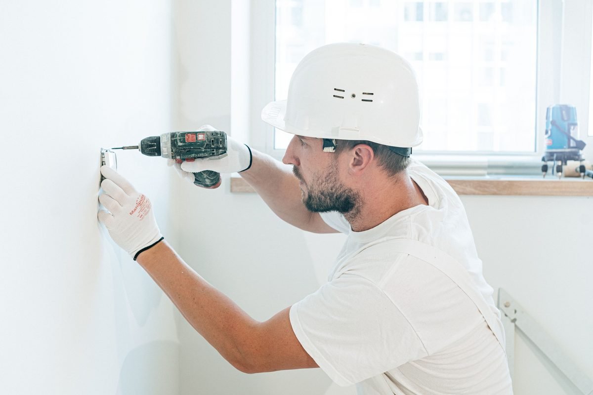 AZ Premier handyman at work, mounting a fixture with a cordless drill